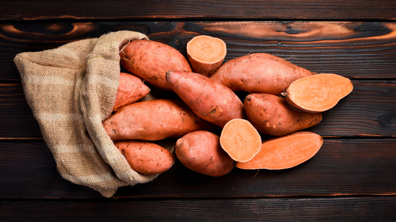 Sweet potatoes spilling from a sack.