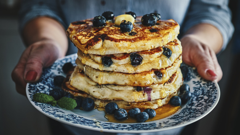 Fluffy pancakes with blueberries and butter