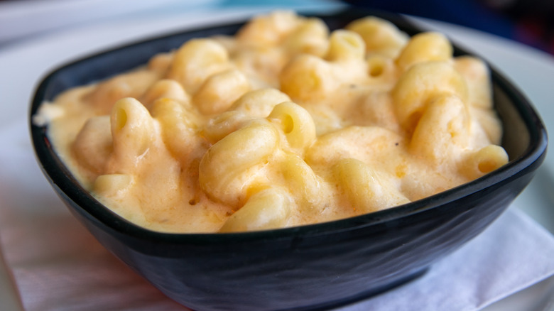 Spiraled mac and cheese served in a black bowl