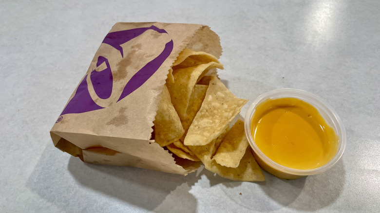 Taco Bell's Chips and Nacho Cheese Sauce on a white table top