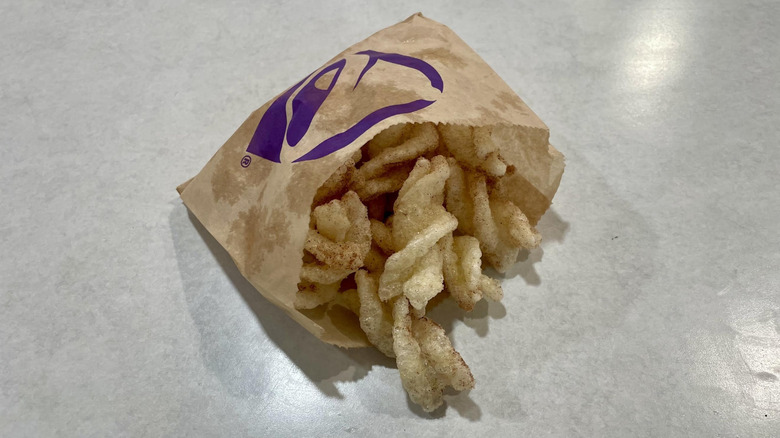 Taco Bell's Cinnamon Twists in a paper bag on a white table top