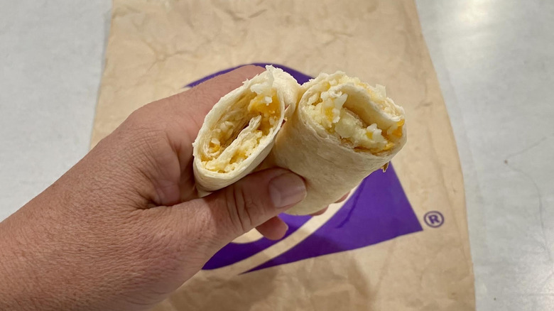Hand holing a halved Cheesy Roll Up