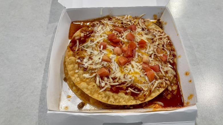 A white paper box with a Taco Bell Veggie Mexican Pizza