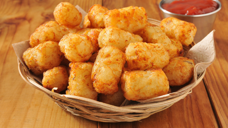 Basket of tater tots on a wooden table