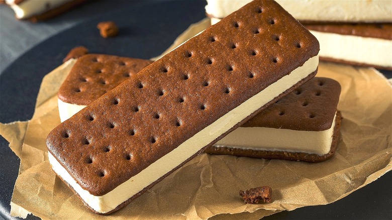 Traditional ice cream sandwiches stacked on parchment paper