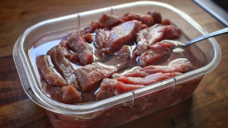 beef strips soaking in water