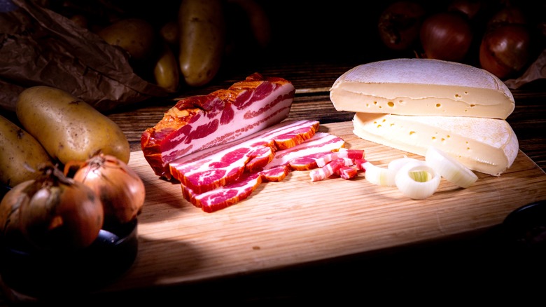 Tartiflette ingredients on a cuttingboard