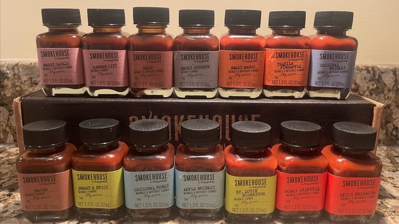 14 bottles of Smokehouse by Thoughtfully BBQ sauce arranged in two rows