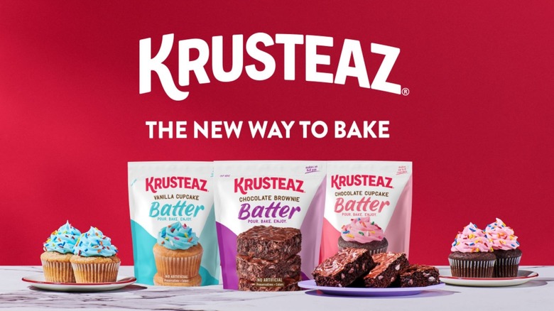 Three Krusteaz batter pouches, with brownies, and vanilla and chocolate cupcakes