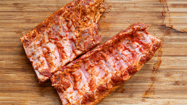 Seasoned ribs on a wooden board