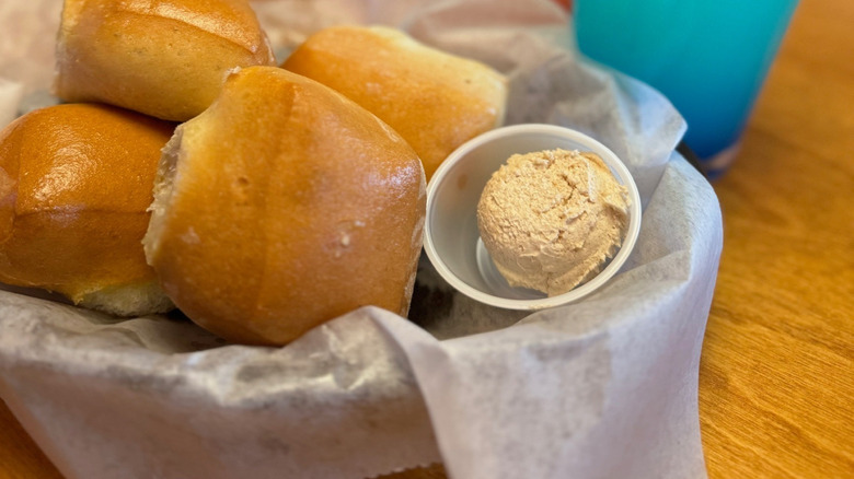 Texas Roadhouse rolls gleam with a side of butter