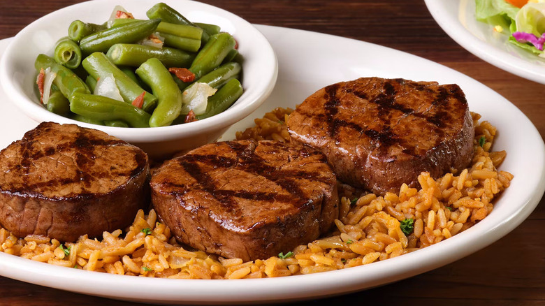 raw steak medallions on a cutting board
