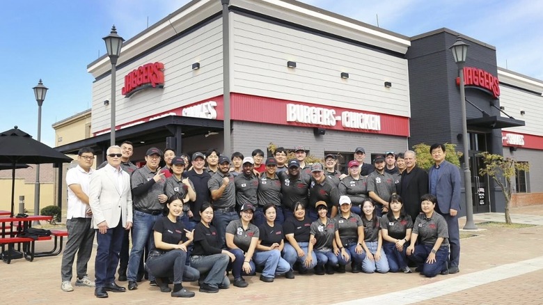 Exterior of Jaggers restaurant at Camp Humphreys with staff posing