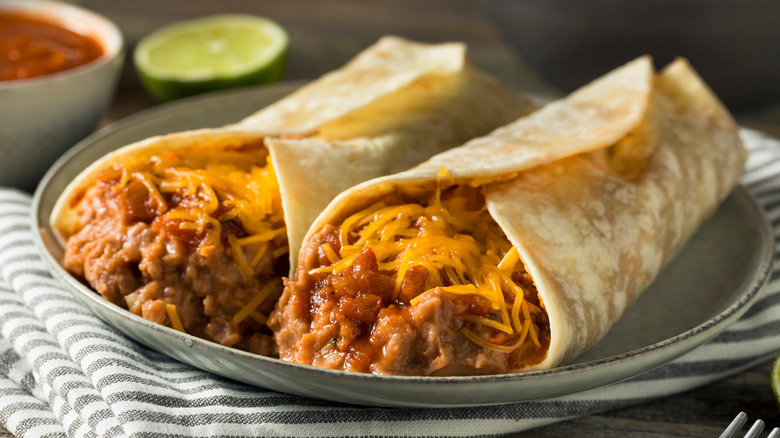 Burritos filled with meat, cheese, and beans