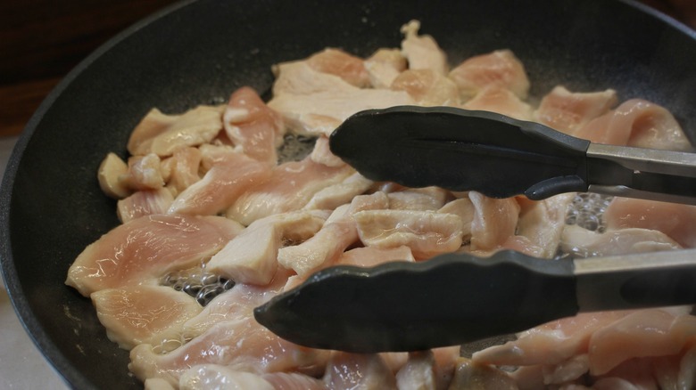 chicken strips cooking in skillet