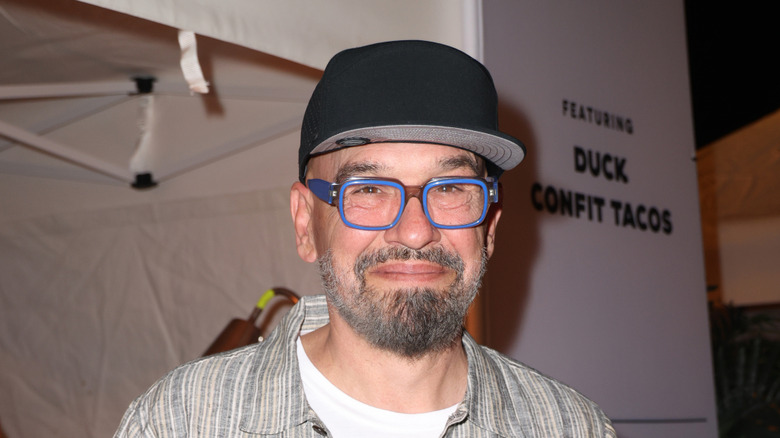 Michael Symon smiling while looking into camera