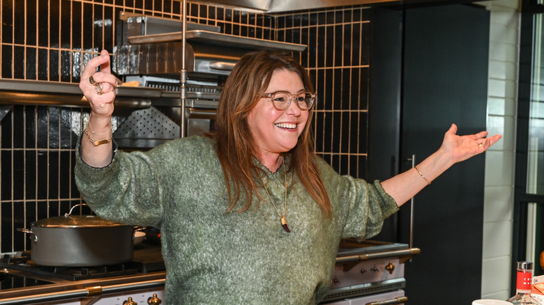 Rachael Ray smiling during a cooking demonstration