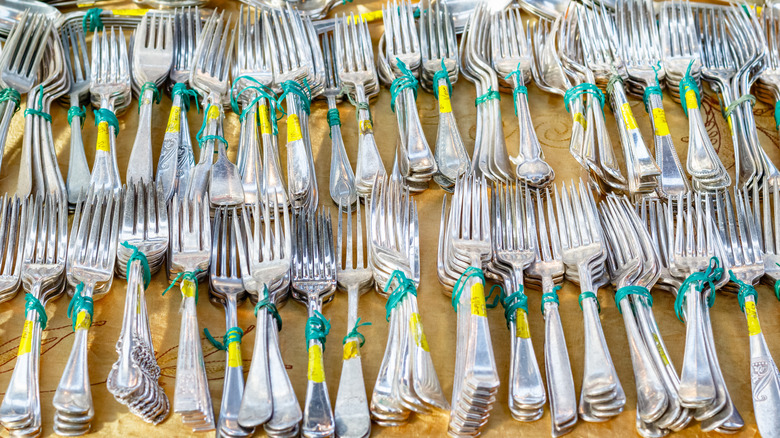 Sets of silverware bunched together for sale