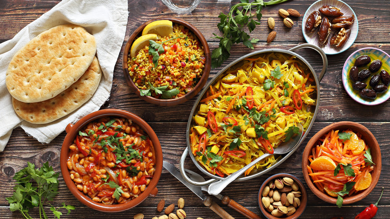 Various serving dishes full of food on table
