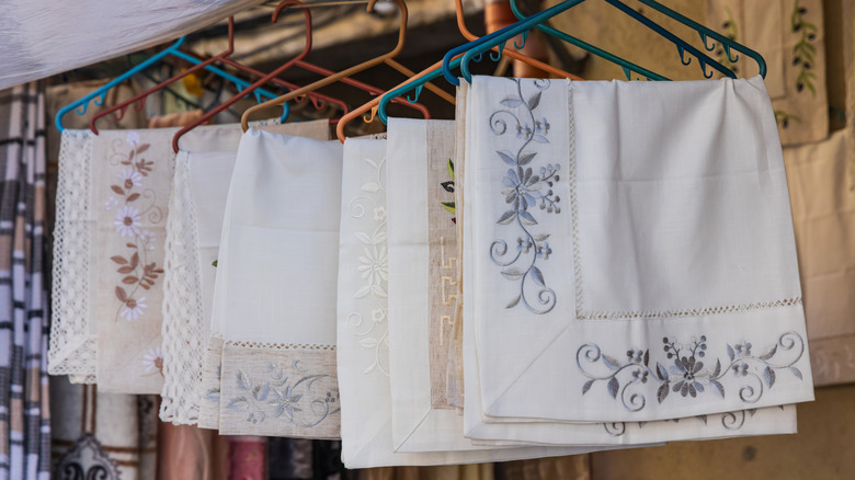 Tablecloths on hangers in secondhand store