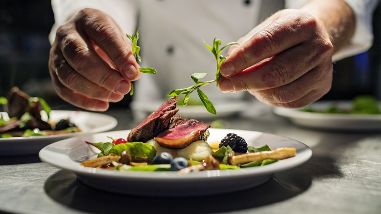 chef arranging plate of food