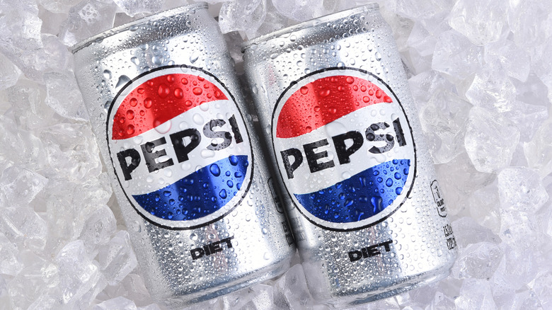 Two cans of Diet Pepsi on a bed of ice