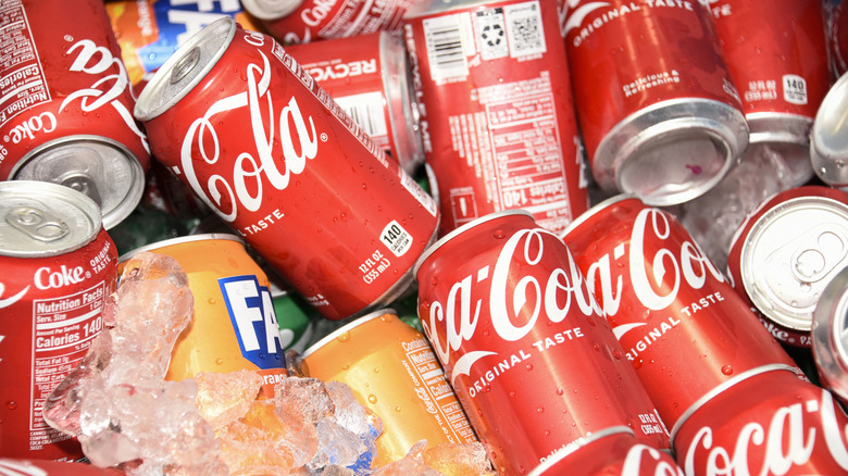 Cans of Coke and Fanta on ice