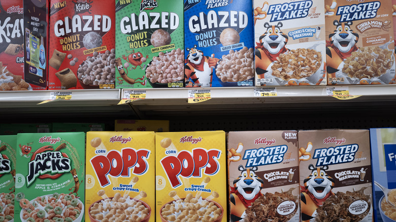 Cereal aisle with several well-known brands displayed.