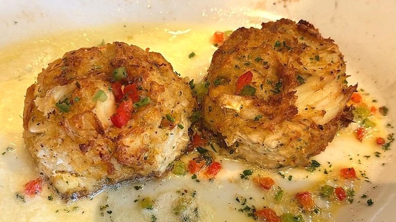 Two crab cakes sit on a plate at Ruth's Chris Steak House