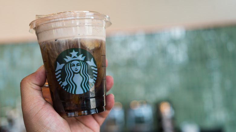 Hand holding a Starbucks Cold Brew