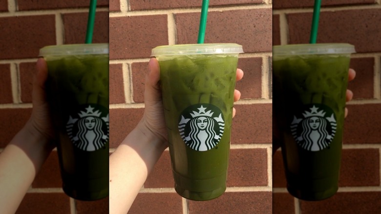 Hand holding Starbucks' Matcha Lemonade