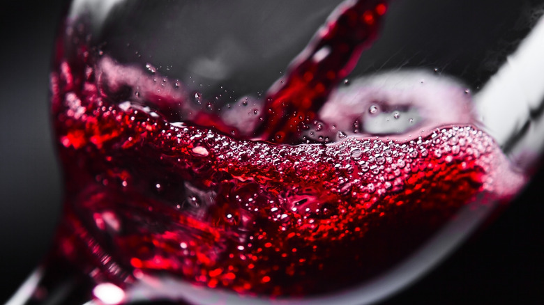 Red wine pouring in glass