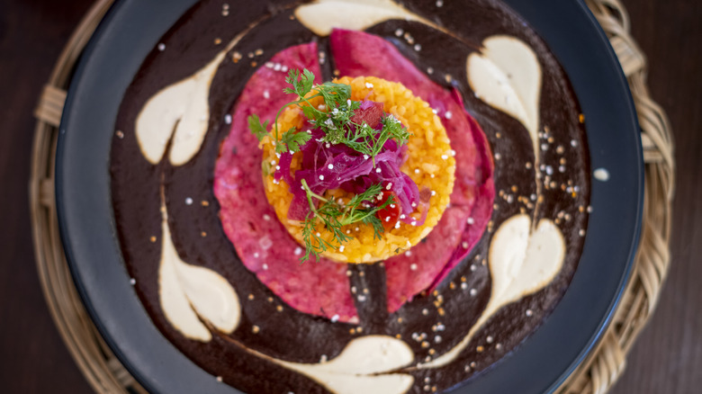 Mole with a pink taco on top