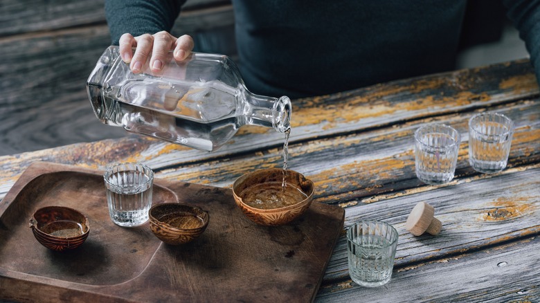 A man pouring mezcal
