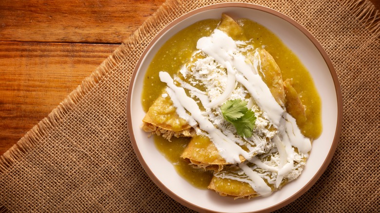 Enchiladas with Mexican crema drizzled on top