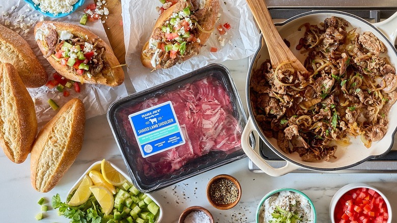 A package of Trader Joe's shaved lamb shoulder next to a bowl of the cooked lamb.