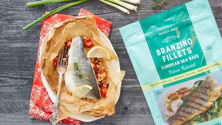 Cooked fish next to Branzino fillets in package.