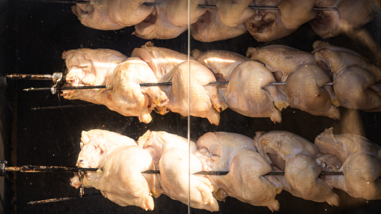 uncooked rotisserie chickens in the oven