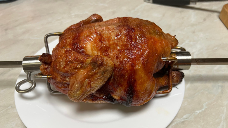 a small rotisserie chicken on a plate
