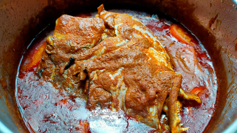Singaporean fish head curry in serving bowl