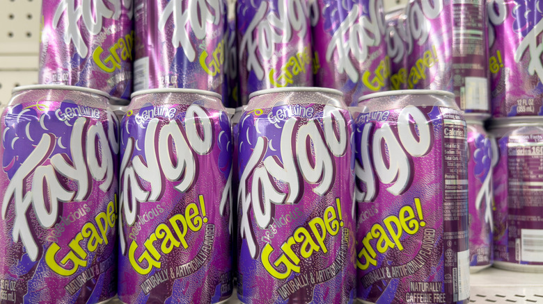 Cans of Faygo Grape soda on display in a store