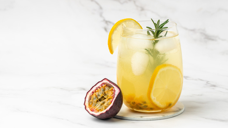 A glass of passion fruit soda with fresh fruit