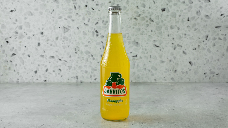 A bottle of Jarritos Pineapple soda