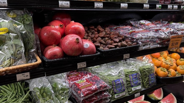 Beautiful produce sits on a refrigerated shelf in a grocery store