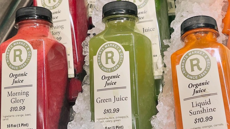 Roberts Market-branded bottles of organic juice sit nestled in ice