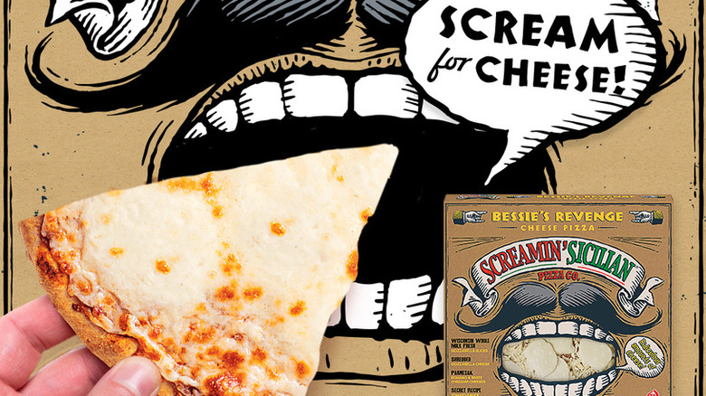 A person holds up a slice of Screamin' Sicilian Bessies Revenge frozen pizza in front of the mouth drawing on the box, with an inset photo of the pizza box on the right