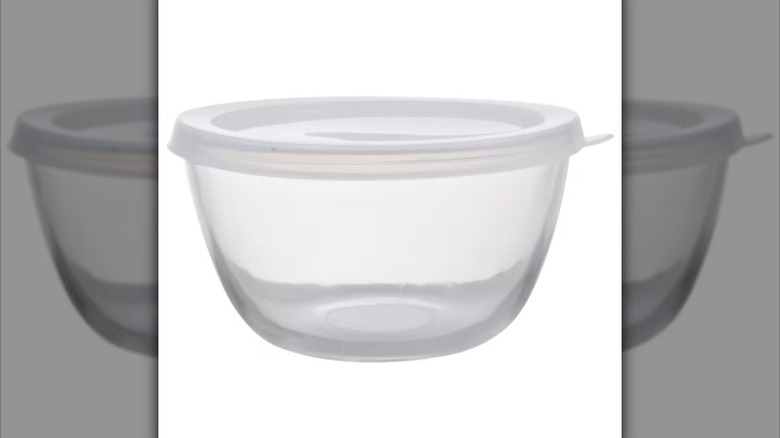 A clear glass bowl with a white plastic lid is displayed against a white background
