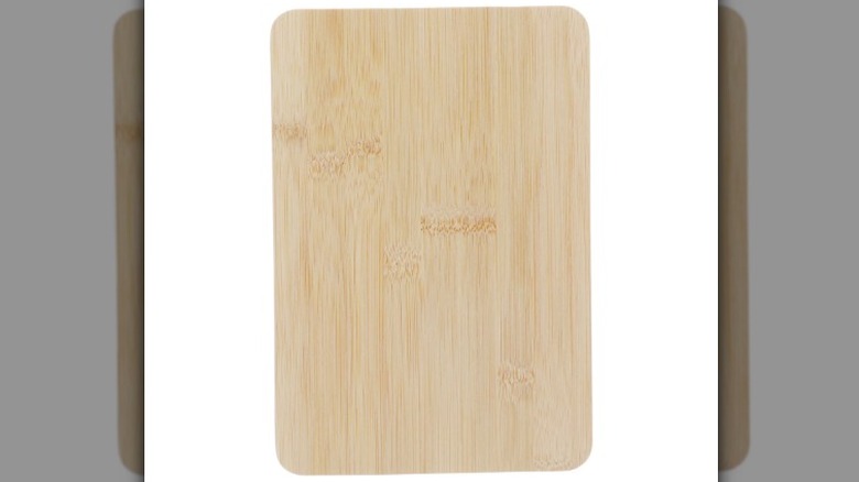 A bamboo cutting board displayed against a white background