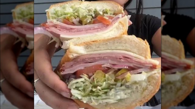a spicy cold cuts sandwich split in half from Eastside Italian deli