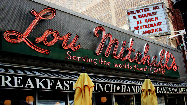 The exterior red neon sign of Lou Michell's